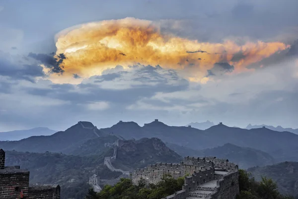 View of a golden cloud in the shape of a whale in the sky after raining at the Jinshanling, a section of the Great Wall of China, in Chengde city, north China\'s Hebei province, 28 May 2017