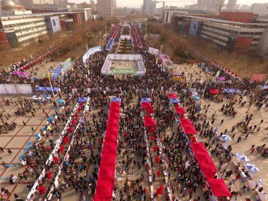 Aerial view of graduates crowding booths to seek for employments during a job fair at a college campus in Shijiazhuang city, north China's Hebei province, 8 February 2017 clipart
