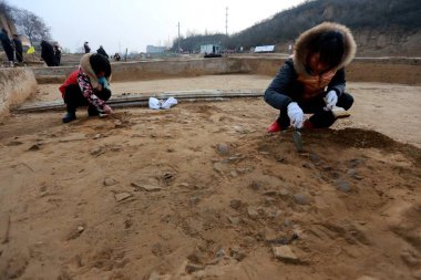 Chinese archaeologists excavate the relics of Zheng Han Old City dating back to the Spring and Autumn period (770 BC to 476 BC) in Xinzheng city, central China's Henan province, 19 February 2017.  clipart