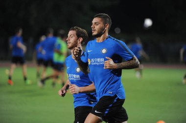 Argentine professional football player Mauro Icardi, right, of Inter Milan, takes part in a training session for the Nanjing match of the 2017 International Champions Cup China against Olympique Lyonnais in Nanjing city, east China's Jiangsu province clipart