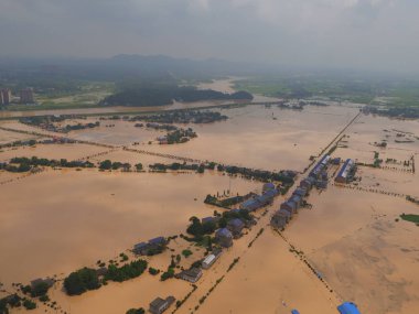In this aerial view, roads and trees are partially submerged by floodwater from the flooded Tuanshan Lake caused by heavy rain in Changsha city, central China's Hunan province, 2 July 2017 clipart
