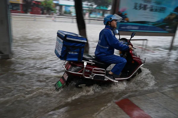 Food Delivery Courier Rides His Electric Bike Flooded Road Caused — Stock Photo, Image