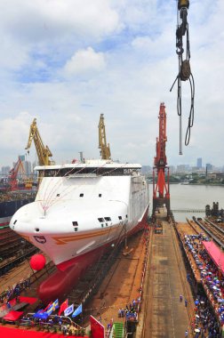 The world's fastest high-end Ro-Ro passenger ship built by Guangzhou Shipyard International Company takes water in Guangzhou city, south China's Guangdong province, 24 July 2017 clipart