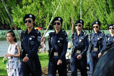 Female guards patrol the West Lake scenic spot in Hangzhou city, east China's Zhejiang province, 16 August 2017 clipart