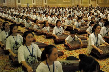 An ensemble of 2500 Guzheng performers perform to create a Guinness World Records in Macau, 21 August 2017 clipart