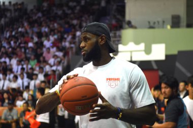 NBA star LeBron James of Cleveland Cavaliers shows his basketball skills during a fan meeting event in Hong Kong, China, 5 September 2017. clipart