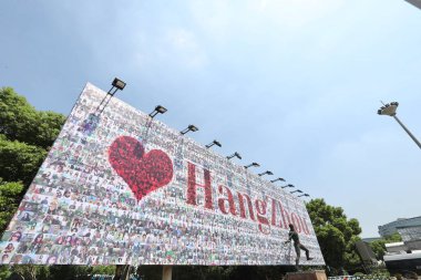 View of a huge poster composed of 60,000 employees' smiling faces, to celebrate the 18th anniversary of the founding of Chinese e-commerce giant Alibaba Group, at Dragon Sports Centre in Hangzhou city, east China's Zhejiang province, 5 September 2017 clipart