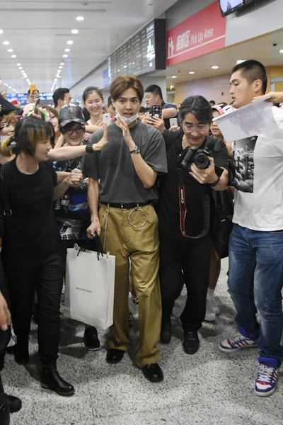 日本歌手 流亡部落的日本男孩乐队一代在中国上海浦东国际机场降落后 被一群球迷围住 紧随其后 — 图库照片