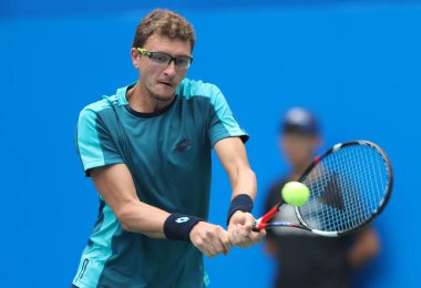 Denis Istomin of Uzbekistan returns a shot to Yuichi Sugita of Japan in their semifinal match of the men's singles during the 2017 Chengdu Open tennis tournament at Sichuan International Tennis Center in Chengdu city, southwest China's Sichuan provin clipart