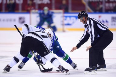 Nick Shore, front, of Los Angeles Kings competes against Vancouver Canucks during the second NHL China preseason hockey game at Wukesong Arena in Beijing, China, 23 September 2017 clipart