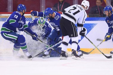 Nick Shore, right, of Los Angeles Kings defends against Vancouver Canucks during the second NHL China preseason hockey game at Wukesong Arena in Beijing, China, 23 September 2017 clipart