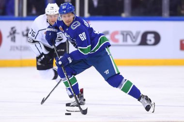 Markus Granlund, front, of Vancouver Canucks competes against Jonny Brodzinski of Los Angeles Kings during the second NHL China preseason hockey game at Wukesong Arena in Beijing, China, 23 September 2017 clipart