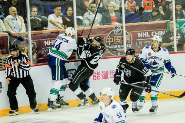 Trevor Lewis of Los Angeles Kings, right, competes against Erik Gudbranson of Vancouver Canucks during the 1st NHL China preseason hockey game at Mercedes-Benz Arena in Shanghai, China, 21 September 2017 clipart