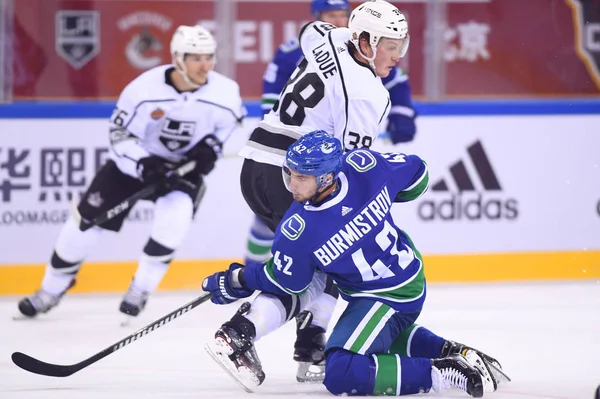 stock image Alexander Burmistrov, front, of Vancouver Canucks competes against Paul LaDue of Los Angeles Kings during the second NHL China preseason hockey game at Wukesong Arena in Beijing, China, 23 September 2017