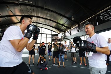 American mixed martial artist Max Holloway, right, the UFC Featherweight Champion, shows boxing skill during an interaction event in Shanghai, China, 3 August 2017. clipart