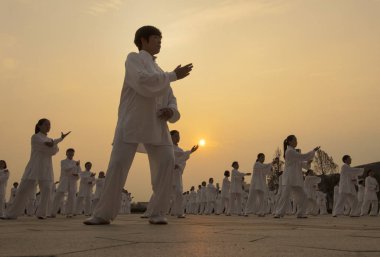 Employees of Shandong Dong-e E-Jiao Group practise Tai chi to mark National Fitness Day which falls on August 8 every year in Dong'e county, Liaocheng city, east China's Shandong province, 5 August 2017 clipart