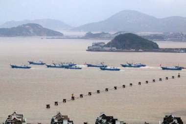 Chinese fishing boats set out to fish in Zhoushan city, east China's Zhejiang province, 1 August 2017 clipart