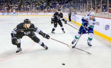 Christian Folin of Los Angeles Kings, left, competes against Sven Baertschi of Vancouver Canucks during the 1st NHL China preseason hockey game at Mercedes-Benz Arena in Shanghai, China, 21 September 2017 clipart