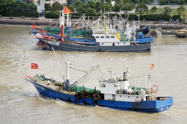 Chinese fishing boats set out to fish from a port in Zhoushan city, east China's Zhejiang province, 17 September 2017 clipart