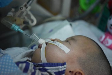 Six-year-old Chinese girl Jin Jin diagnosed with brainstem encephalitis, who has been in coma and lived on a respirator for more than 300 days, is pictured in the ICU of Children's Hospital of Zhengzhou in Zhengzhou city, central China's Henan provin clipart