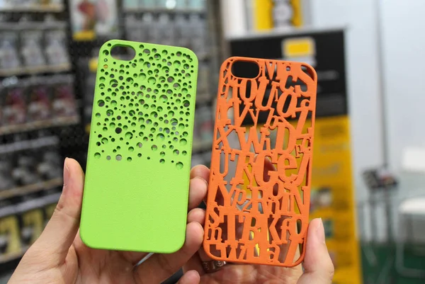 stock image A visitor shows a 3D printed phone cases for Apple's iPhone smartphones during the 2013 Macworld iWorld Asia (MIA) in Beijing, China, 25 August 2013