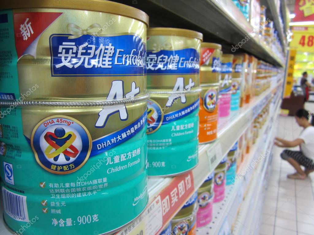 Tins of Mead Johnson milk powder are for sale at a supermarket in Nantong city, east China's Jiangsu province, 23 December 2013.