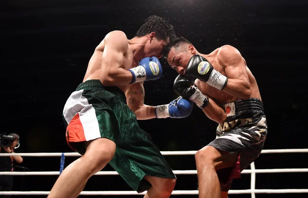 Li Leshan of China, left, competes against Takuya Watanabe of Japan during the WBO super featherweight  intercontinental title bout during the Clash of Champions 3 at Hong Kong Convention and Exhibition Center in Hong Kong, China, 8 October 2017