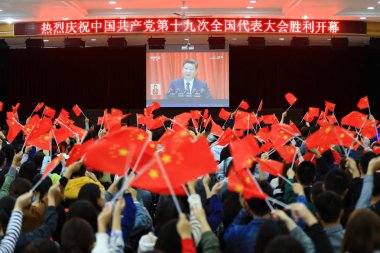 Students from Huaibei Normal University watch the live broadcast of Chinese President Xi Jinping delivering a report during opening session for the 19th National Congress of the Communist Party of China (CPC) in Huaibei city, east China's Anhui provi clipart