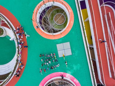 Aerial view of running tracks on the rooftop of a building at a newly-opened kindergarten in Huzhou, east China's Zhejiang province, 17 October 2016 clipart