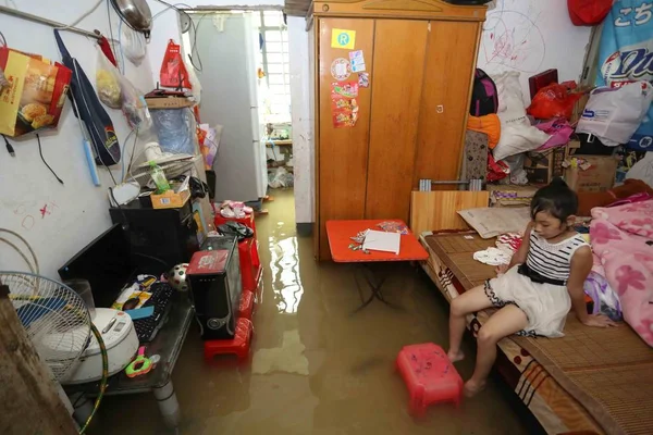 Young Chinese Girl Sits Bed Her Flooded House Heavy Rain — Stock Photo, Image