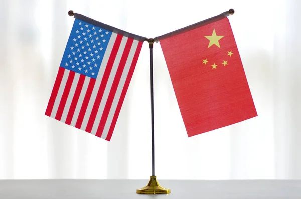 National flags of China and the United States are seen in Ji\'nan city, east China\'s Shandong province, 14 June 2018.