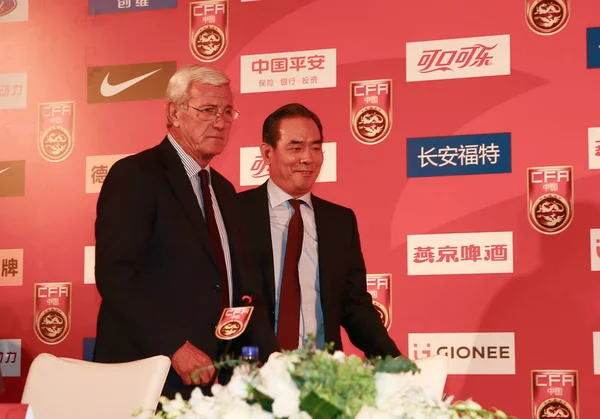 stock image Marcello Lippi, left, newly-appointed head coach of the Chinese national football team, and Cai Zhenhua, former Chinese table tennis player and President of the Chinese Football Association (CFA), attend the CFA Team China press conference in Beijing