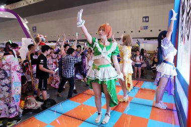 Visitors watch a performance of entertainers dressed in cosplay costumes during the 12th China International Cartoon & Game Expo (CCG Expo 2016) in Shanghai, China, 7 July 2016 clipart