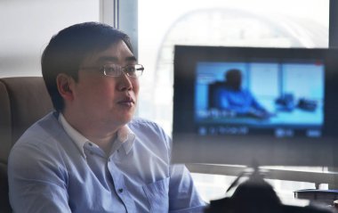 Cheng Wei, co-founder and CEO of taxi hailing app Didi Chuxing, is pictured at an interview in Beijing, China, 7 April 2013 clipart