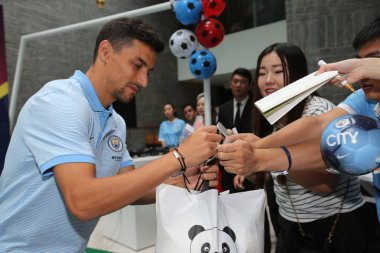 Samir Nasri, left, of Manchester City signs autographs for fans at a fan party for the Beijing match of the 2016 International Champions Cup China in Beijing, China, 24 July 2016. clipart