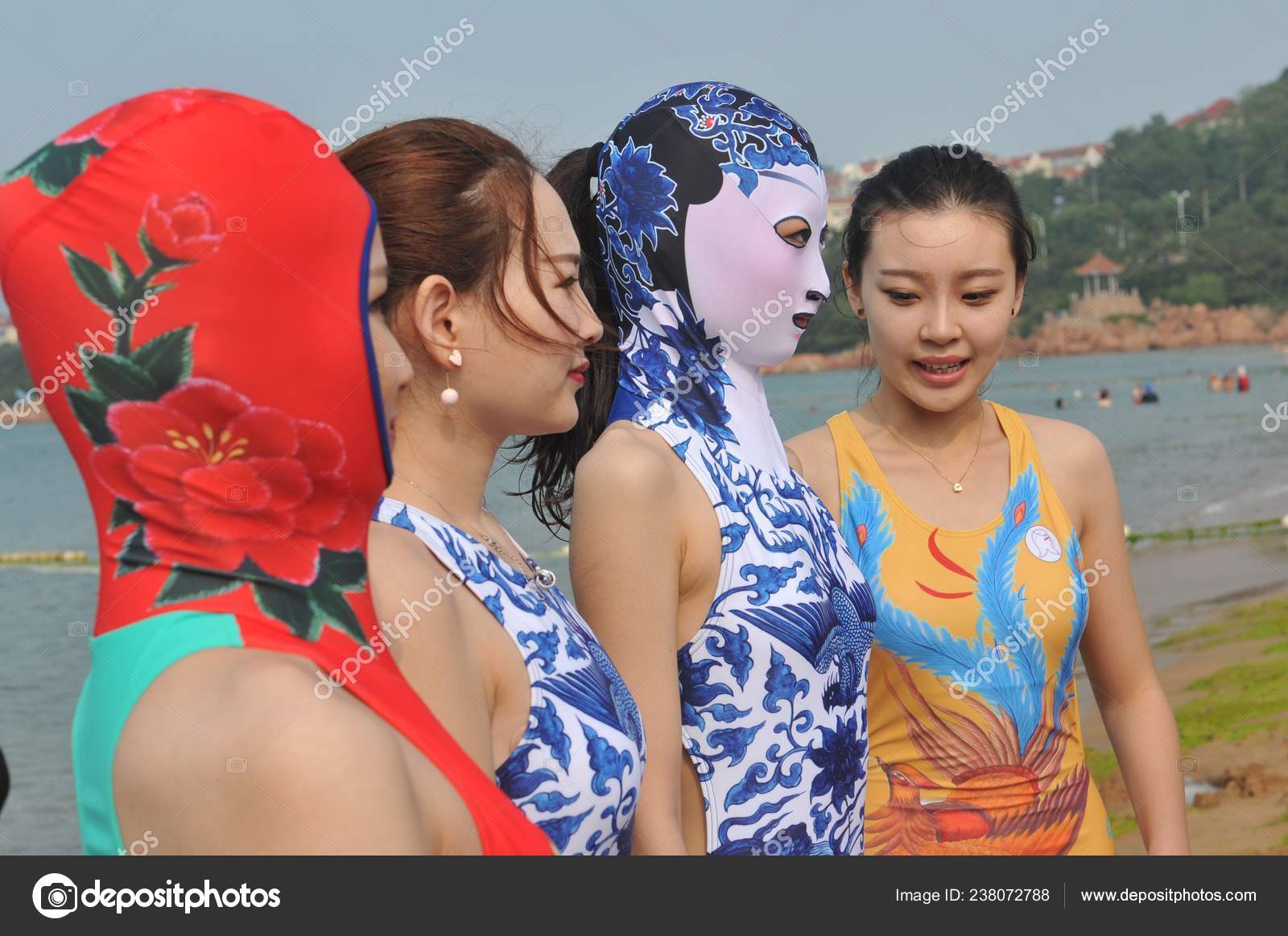 Model Second Right Wearing Facekini Swimsuit Featuring Blue White