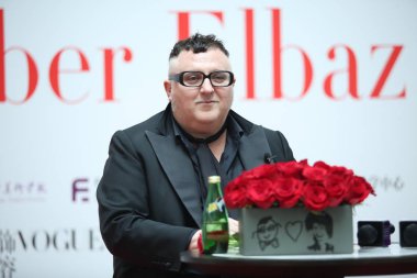 Alber Elbaz, former fashion designer of Paris fashion house Lanvin, attends a dialogue with Chinese fashion journalist Angelica Cheung, editor-in-chief of Vogue China, at Tsinghua University in Beijing, China, 31 March 2016. clipart