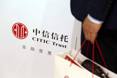 A man visits the stand of CITIC Trust during an expo in Shanghai, China, 6 November 2015 clipart