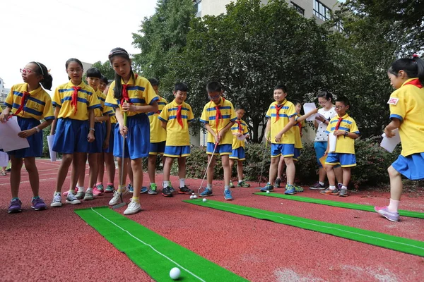 ファイル 中国の若い学生が杭州 Tianchang 小学校の遊び場でのプレイグラウンドでゴルフをします東シナの浙江省 杭州市の新しい学期の初日 9月1日2014 — ストック写真