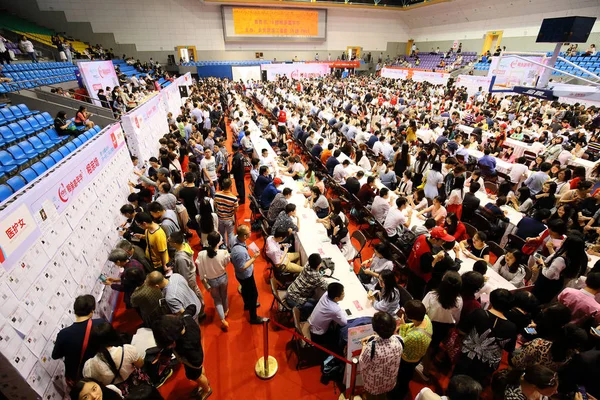 Unmarried young people chat in pairs during a matchmaking event at the Yuquan Campus of Zhejiang University in Hangzhou city, east China's Zhejiang province, 29 May 2016