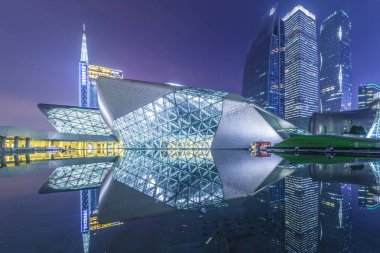 Night view of the Guangzhou Opera House designed by Iraqi-British architect Zaha Hadid in Guangzhou city, south China's Guangdong province, 16 May 2015 clipart