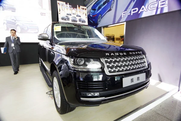 Chiński Sprzedawca Mówi Jego Telefon Komórkowy Obok Range Rover Suv — Zdjęcie stockowe