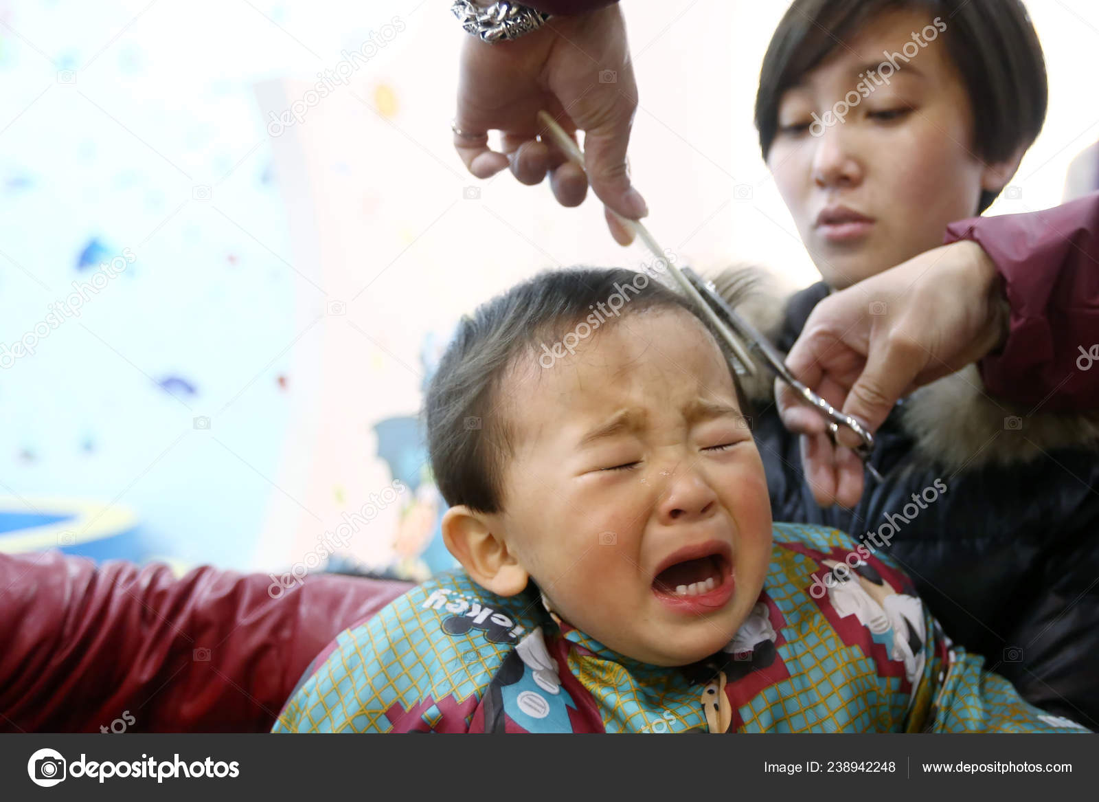 Young Chinese Boy Weeps While Having His Hair Cut Barber Stock