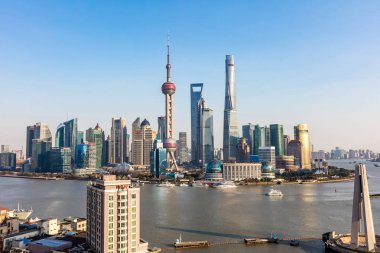 Skyline of Puxi, Huangpu River and the Lujiazui Financial District with the Oriental Pearl TV Tower, left tallest, the Shanghai Tower, right tallest, the Shanghai World Financial Center, center tallest, the Jinmao Tower. clipart