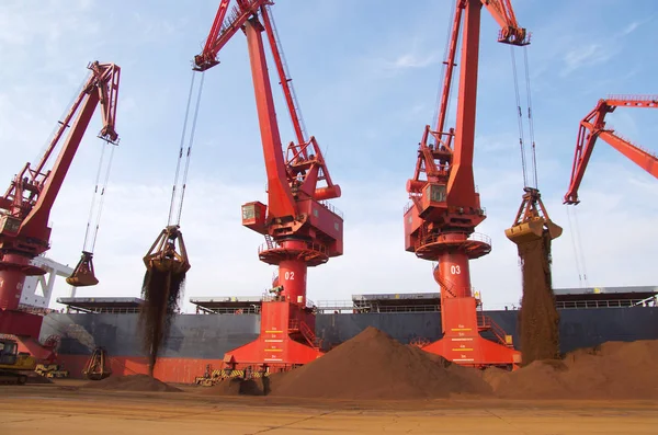 グラブバケツは 貨物船から輸入された鉄鉱石を 中国東部の山東省Rizhao市のRizhao港の岸壁に降ろします 2015年12月6日 — ストック写真