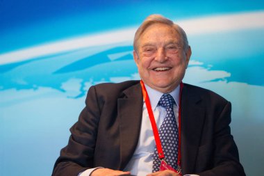Billionaire investor George Soros, chairman of Soros Fund Management and founder of The Open Society Institute, reacts at a sub-forum during the Boao Forum for Asia Annual Conference 2013 in Qionghai city, south China's Hainan province, 8 Apr clipart