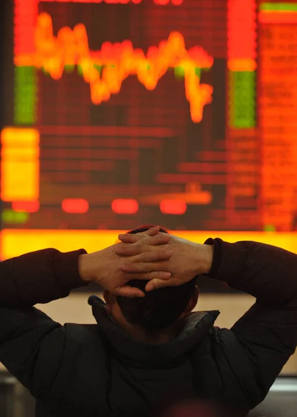 2016 日中国東部の安徽省阜陽市で証券家で株価指数を見て懸念している中国語の投資家 — ストック写真
