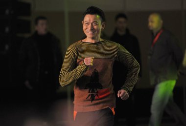 Hong Kong actor Andy Lau rushes for a press conference to promote his new movie 
