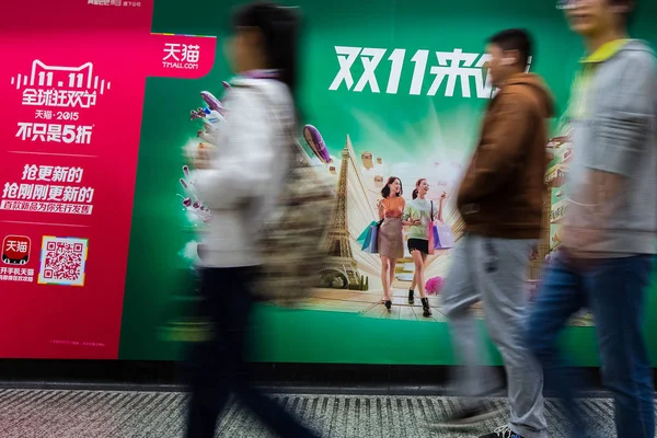 歩行者は 中国の上海の地下鉄駅でシングルスの日に Tmall オンラインショッピングフェスティバルの広告を過ぎて歩く 10月29日2015 — ストック写真