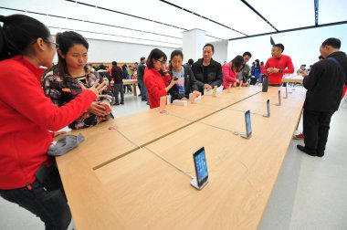 Customers shop for iPhone 6s and 6s Plus smartphones at an Apple Store in Nanning city, south China's Guangxi Zhuang Autonomous Region, 12 December 2015 clipart